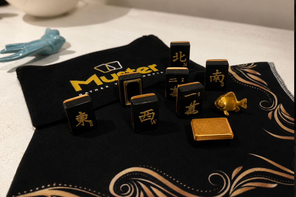 Dynasty Noir mahjong tiles in black and gold with Muster branding